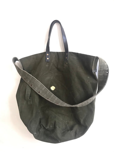 green bag with shoulder handle and smaller leather handles fabric repaired with kintsugi japanese goldpaste